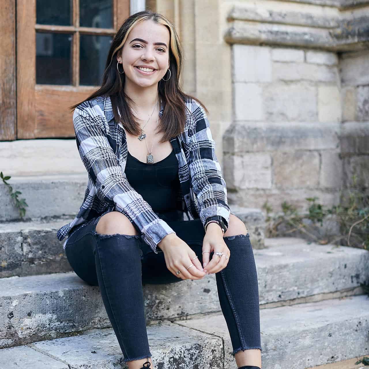 Student smiling on University steps