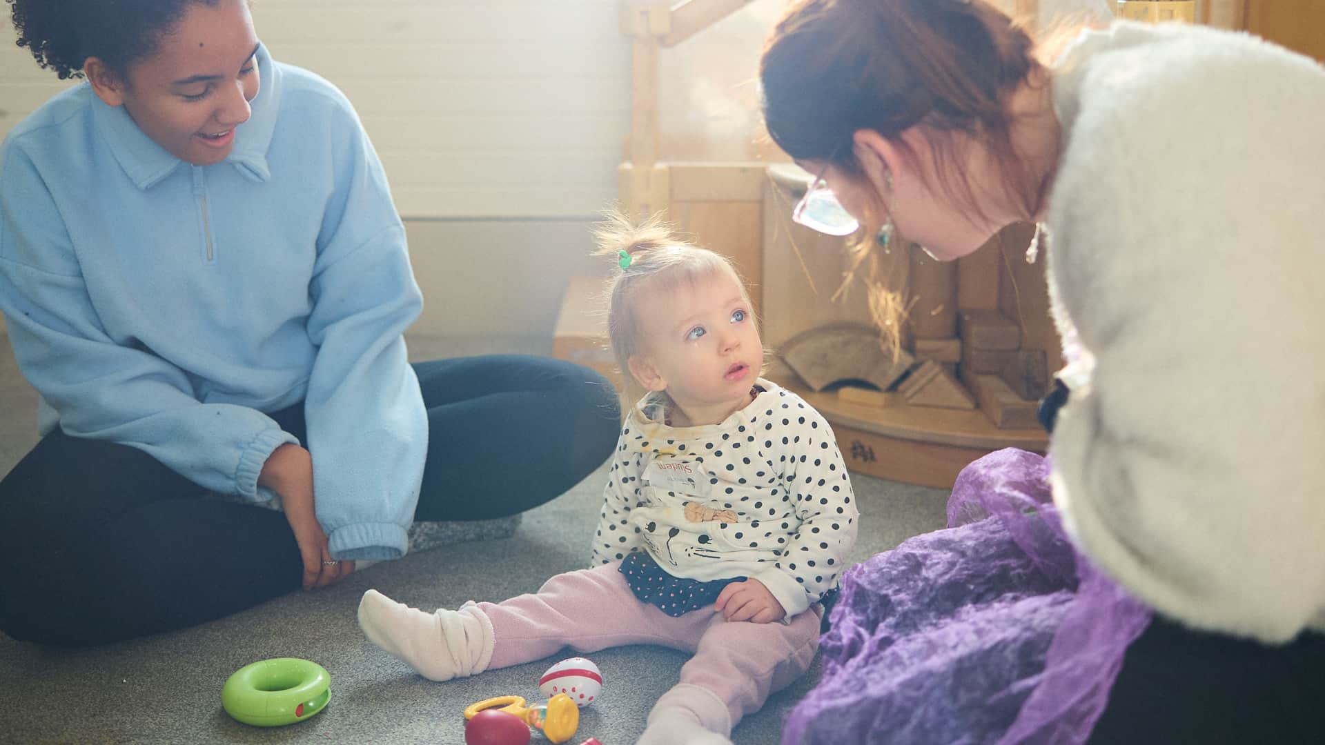 Student playing toys with young child