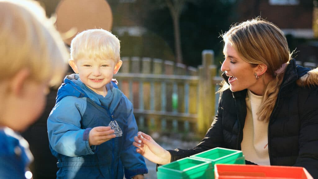 Student outside with kids playing