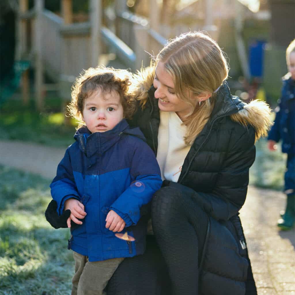 student holding small child in playground