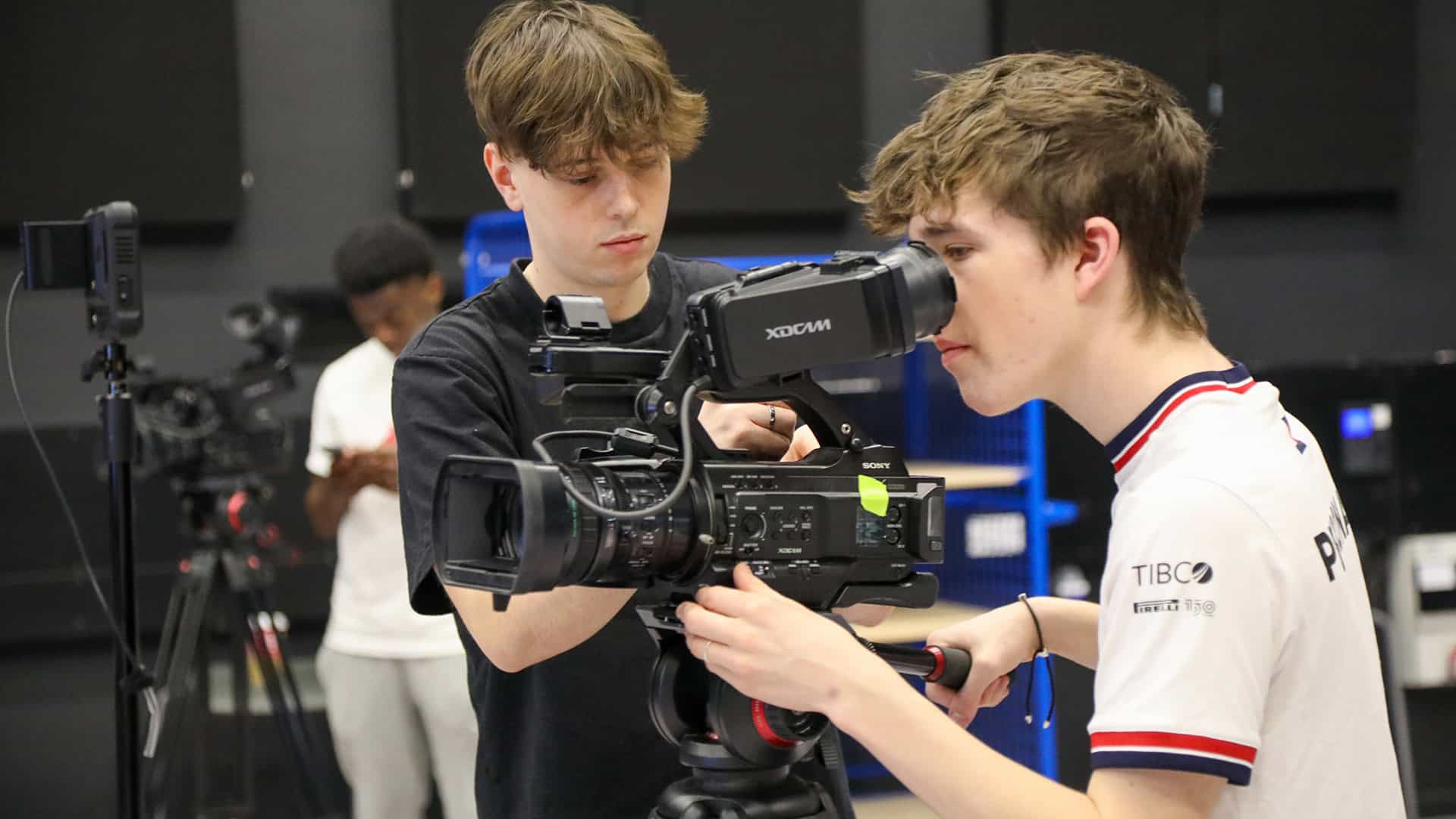 sports media students using camera equipment