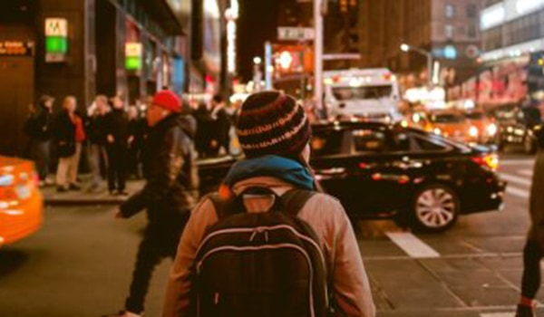 Student in a city at night