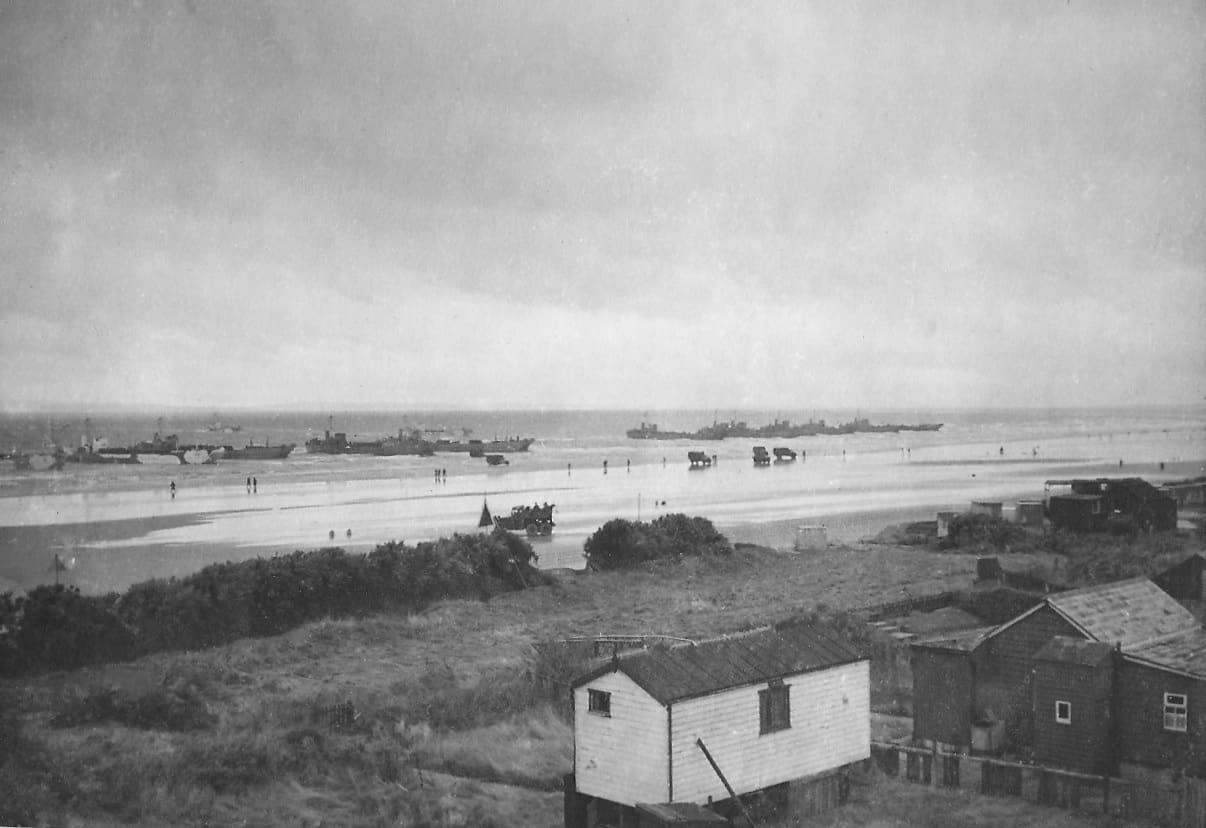 House on coastline with sea in background
