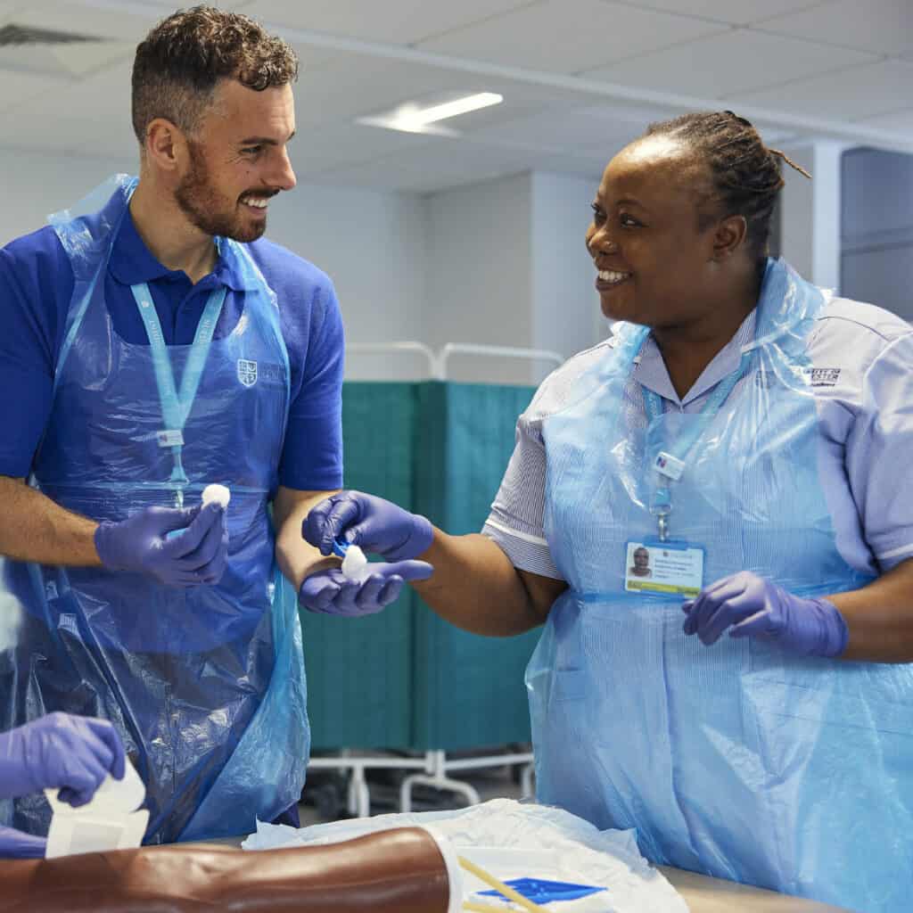 Two nursing students smiling in PPE