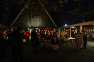 The crowd at the vigil for transgender day of remembrance holding candles