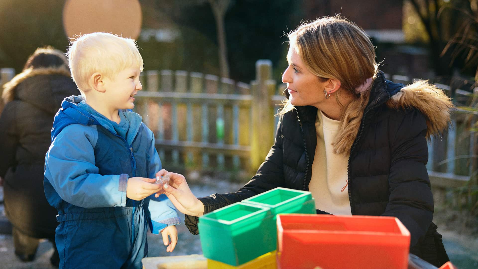 girl talking to child in playground