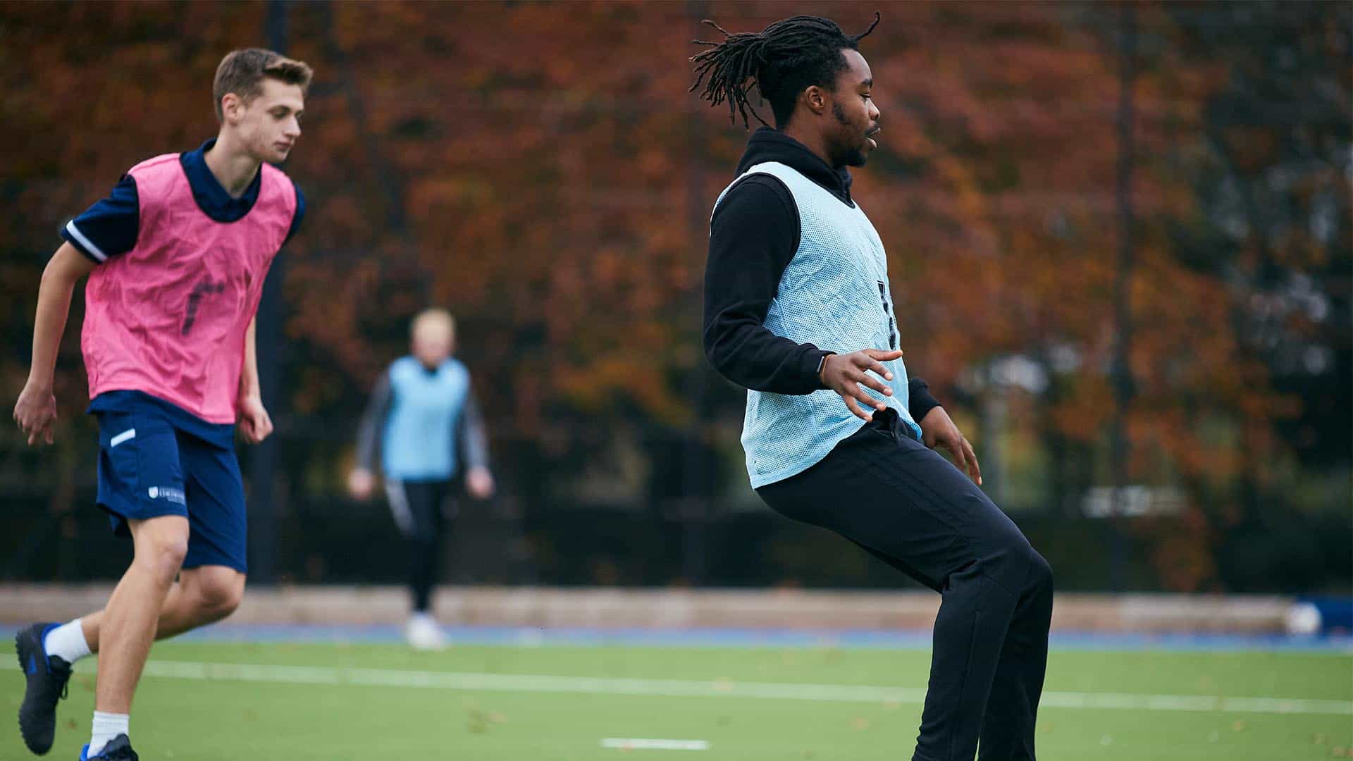 Football students playing on the astro