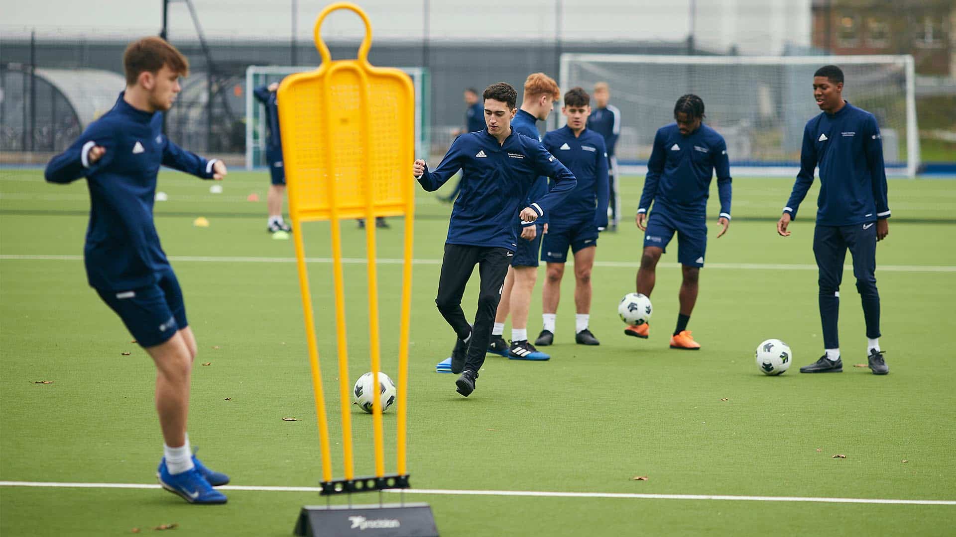 Football students playing on the astro