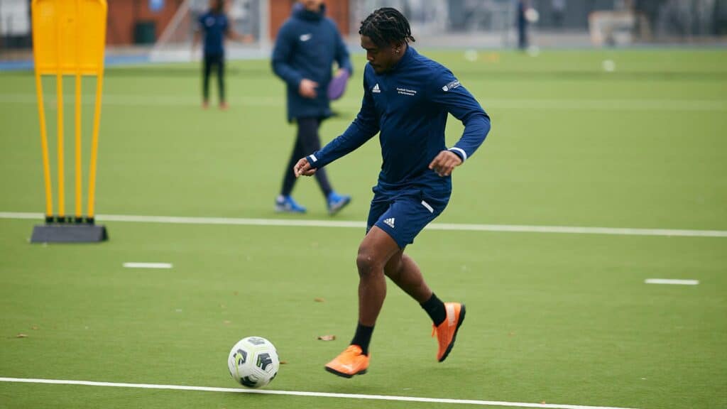 Football students playing on the astro