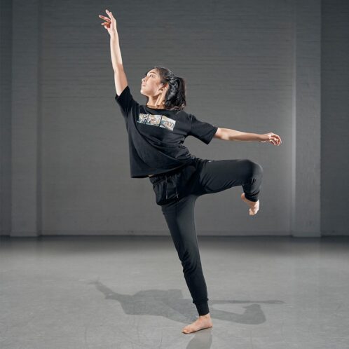 Dance student practicing a move in the studio