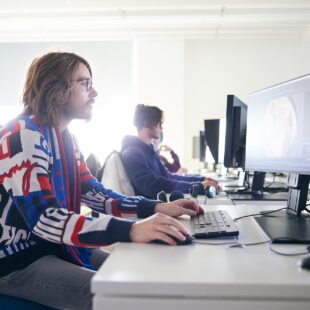 students sat at computers in an engineering lecture