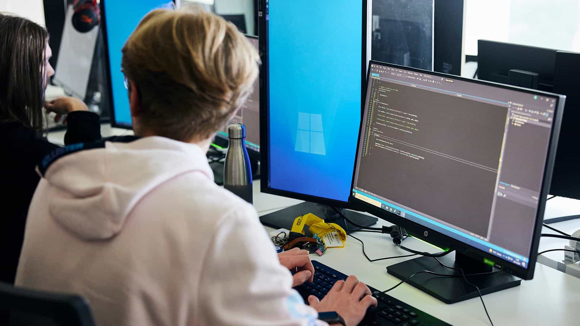Students coding on their computers