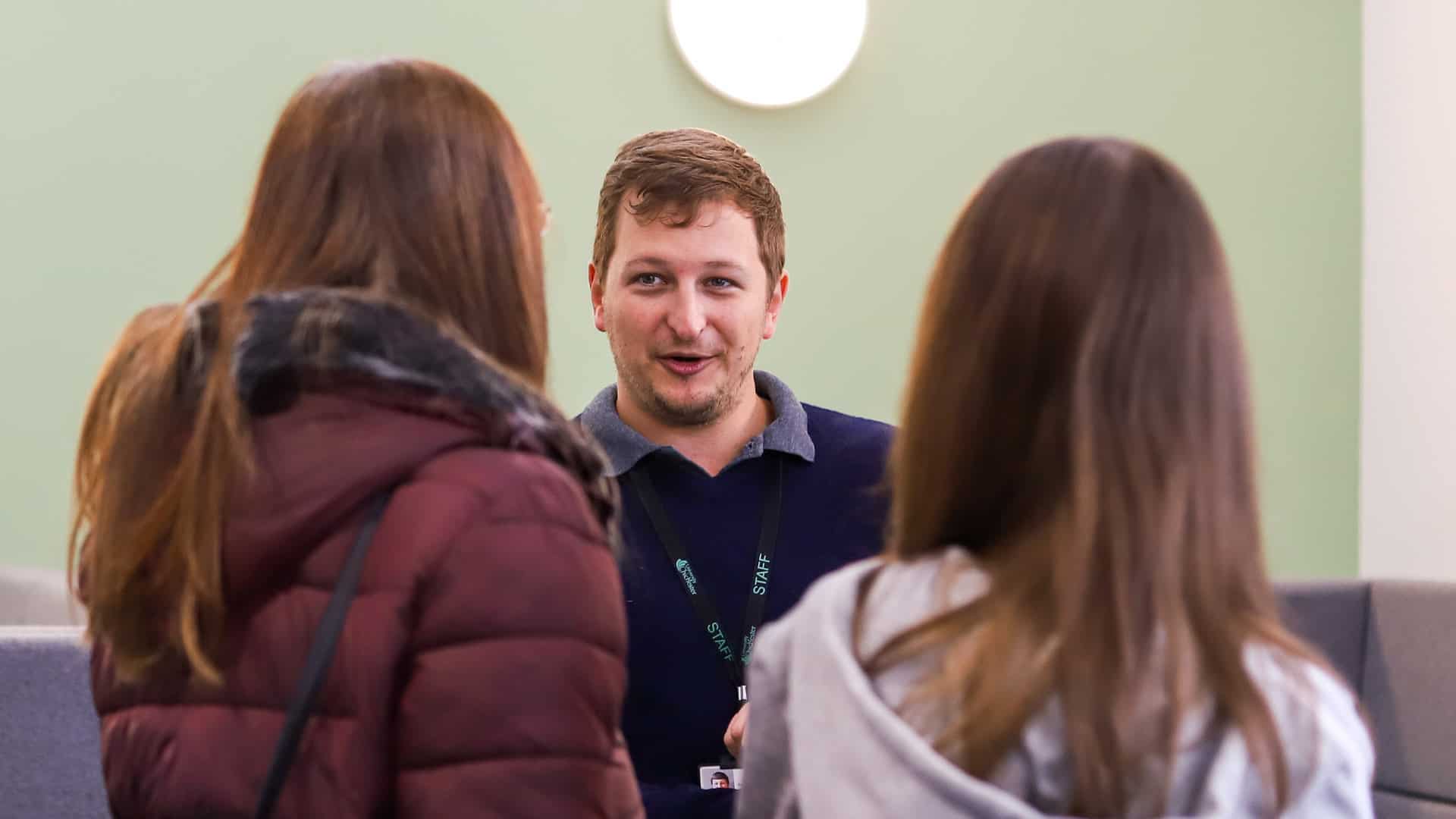 21 Open Day 12 Open Day visitors speaking to a member of staff