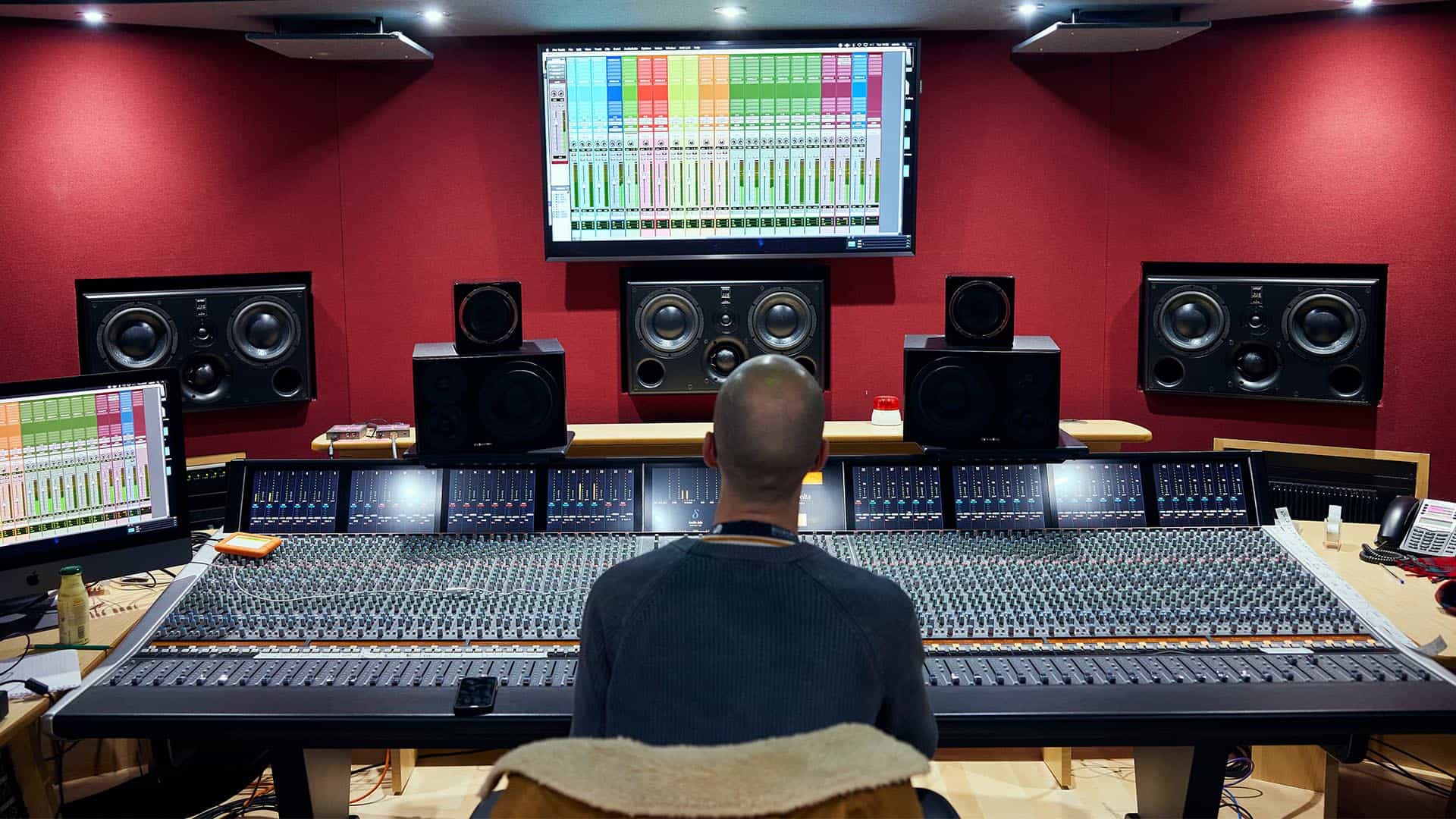 21 Audio Prod 0027 21 Audio Production (3) Audio production lecturer sat in audio production studio looking at the screen