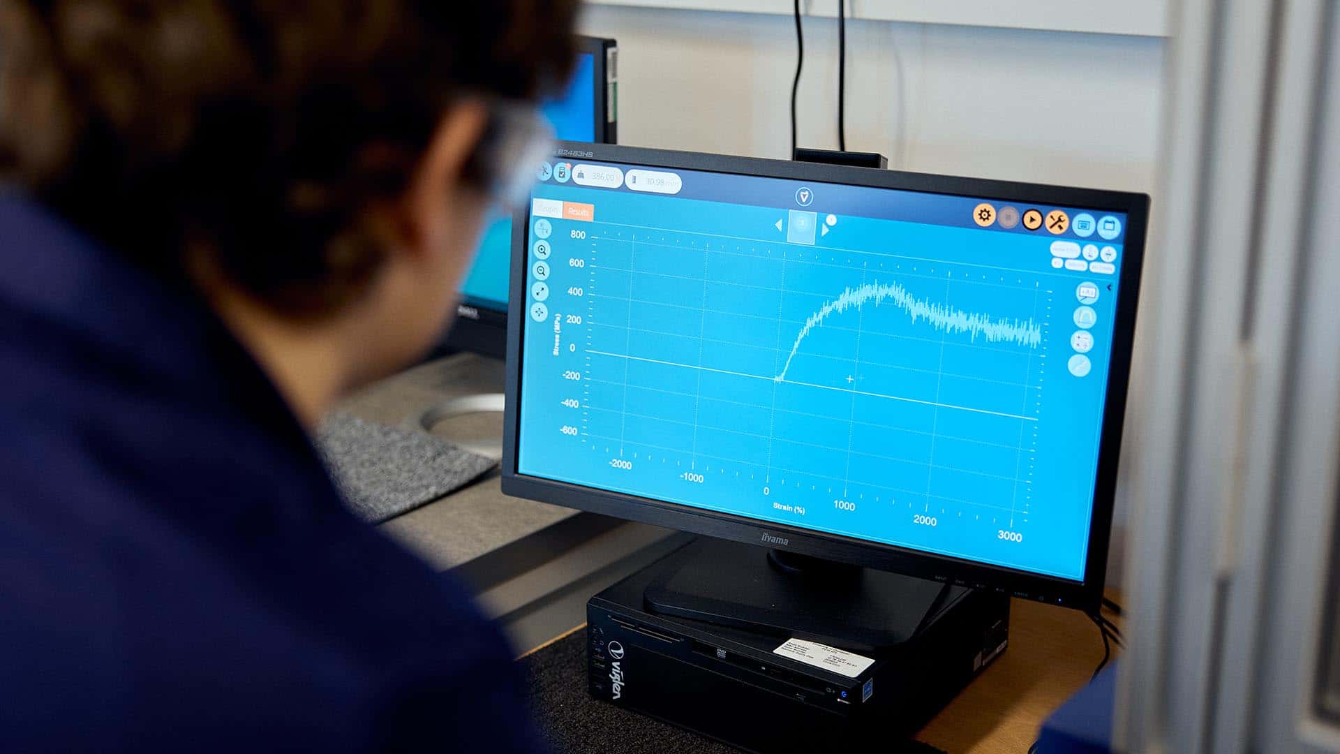 Engineering student looking at a monitor