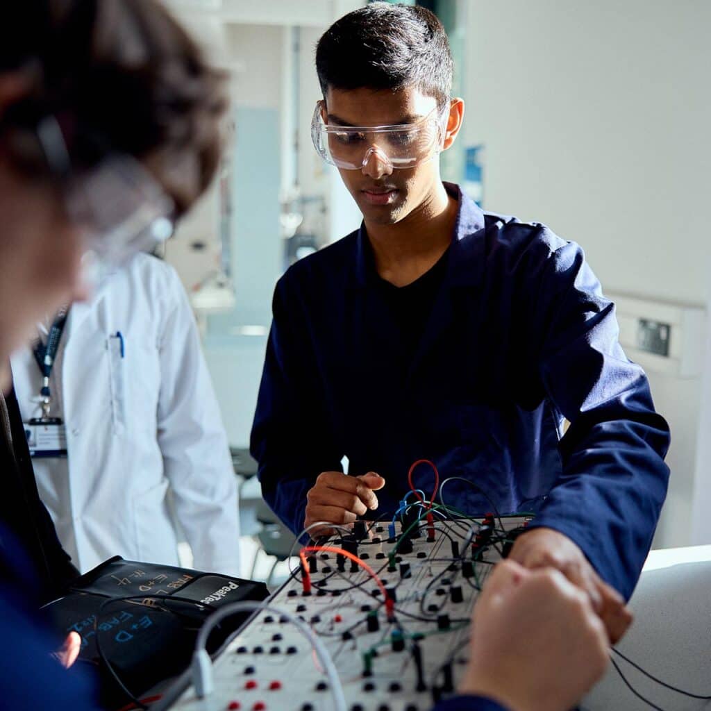 Engineering students working together with a teachers help