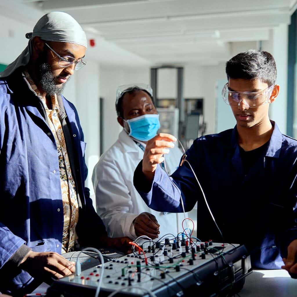 Engineering students working together with a teachers help