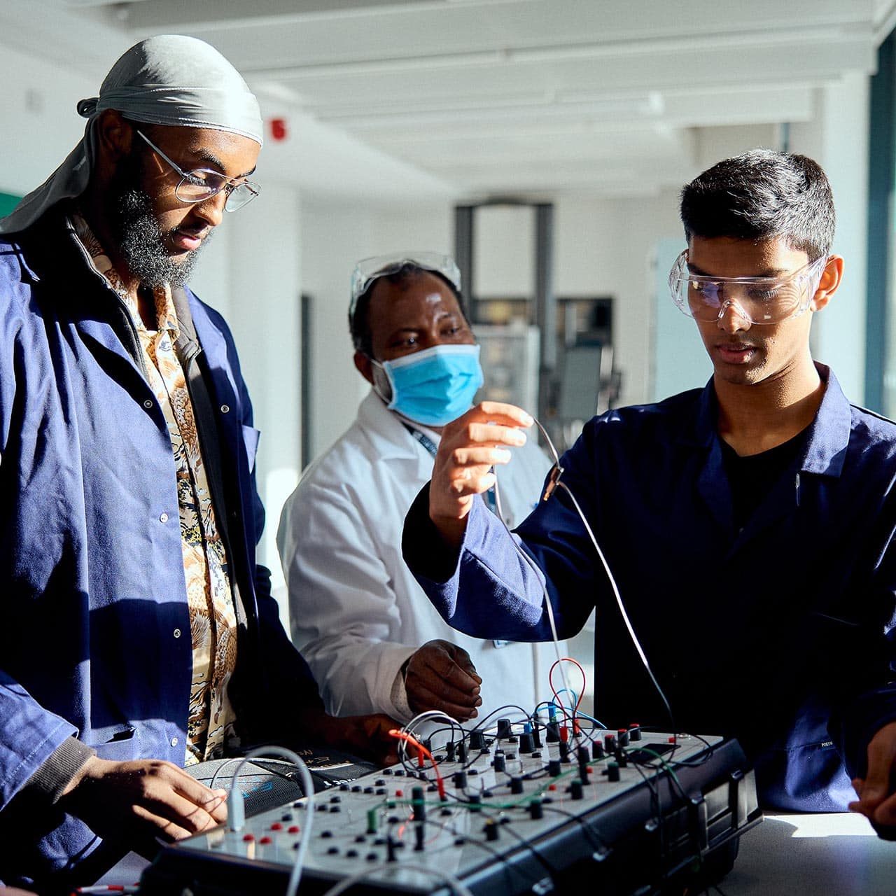 Engineering students working together with a teachers help