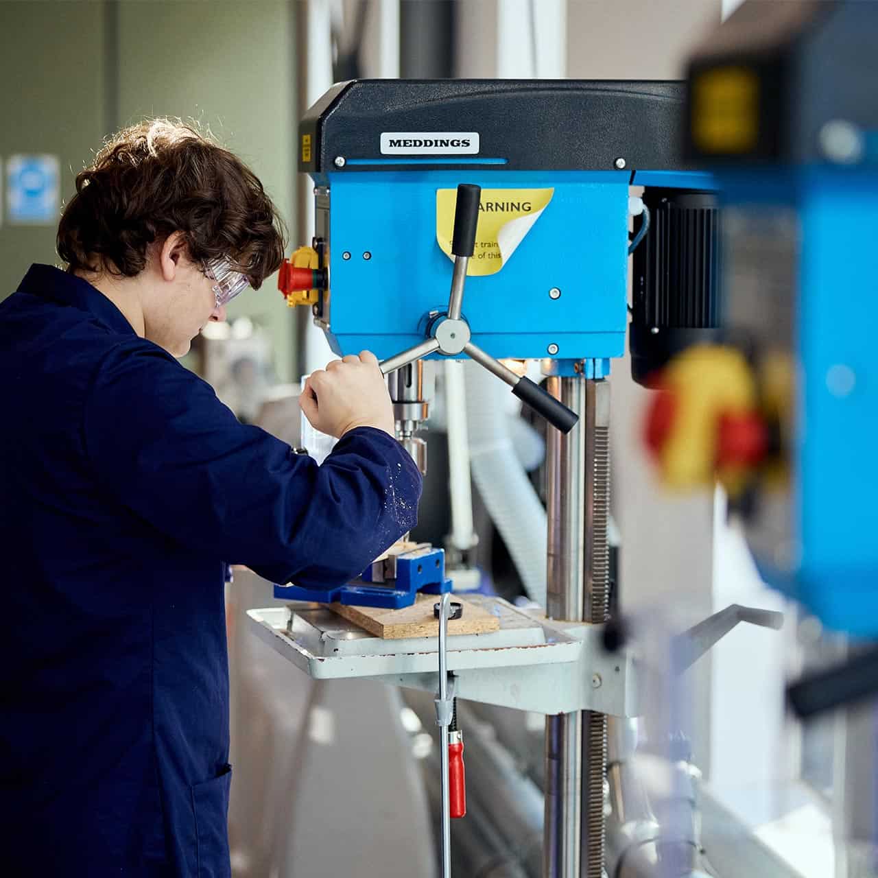 Engineering student using workshop equipment