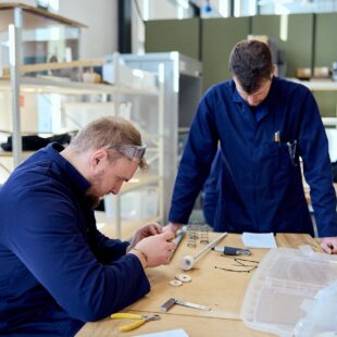 Engineering students using equipment in the workshop