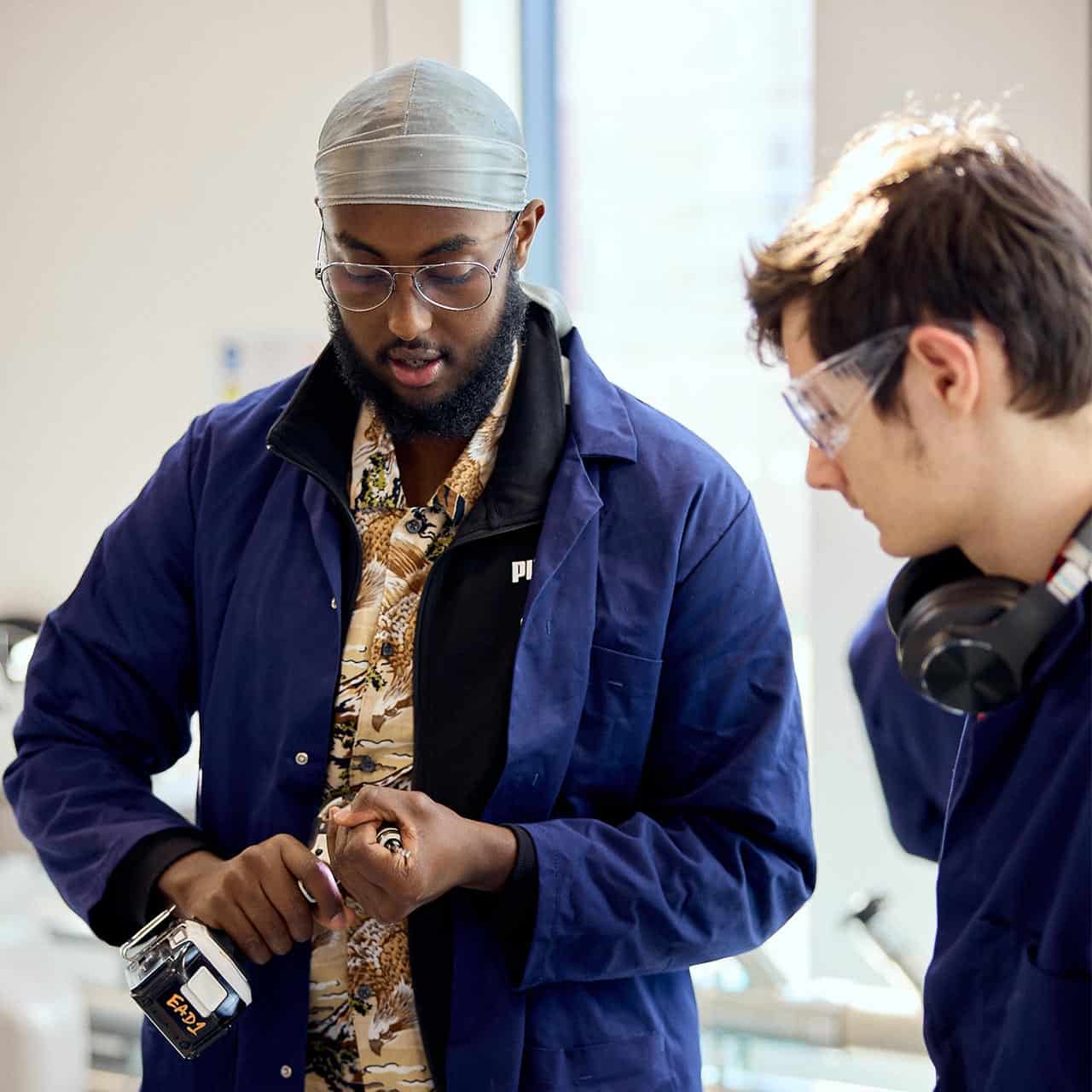 Engineering students using equipment in the workshop