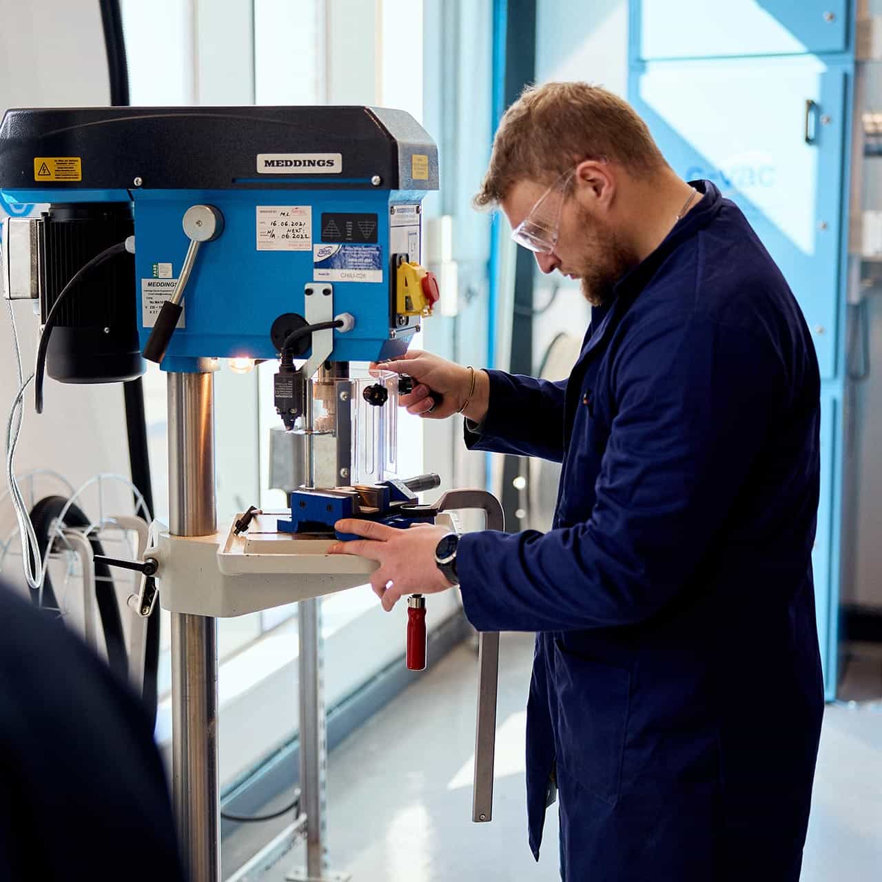 Engineering student using equipment in the workshop