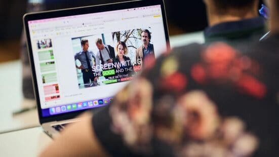 Screenwriting student sat at their laptop with their presentation on display