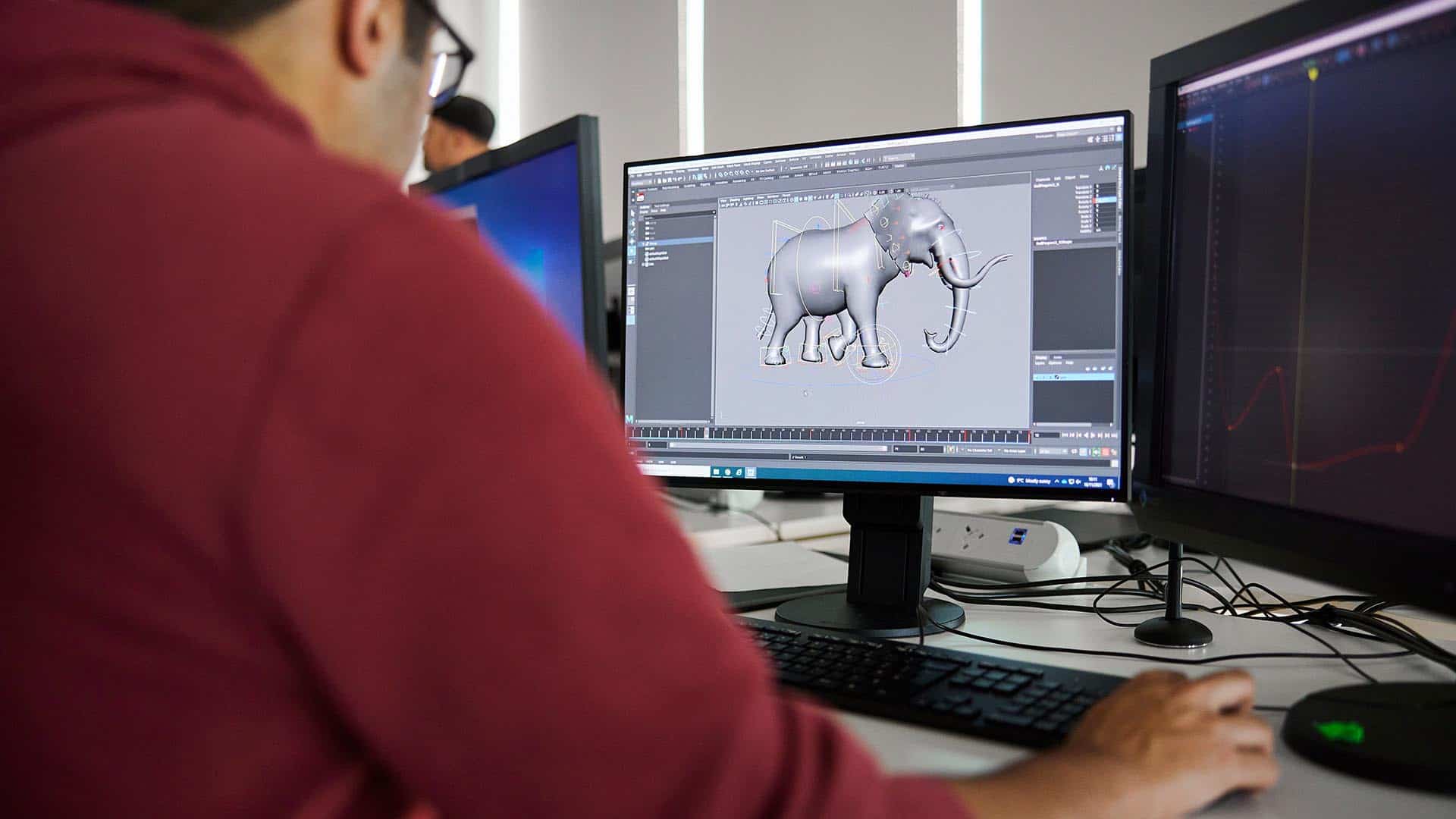 3D animation students working on a 3D elephant model