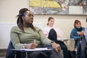 Student sat at desk in seminar room