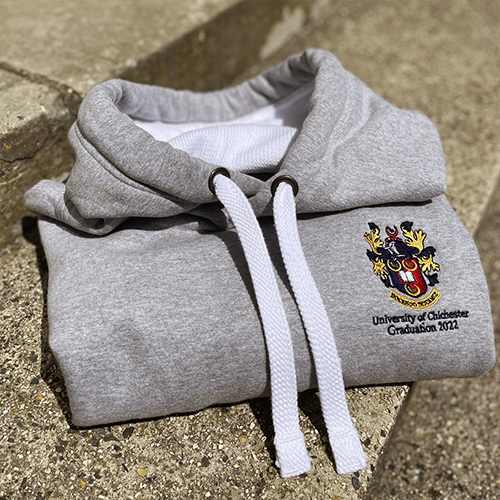 Grey graduation hoodie folded on step