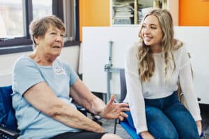 Staff member talking to SAGE house service user