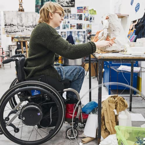 Fine art students working at a desk