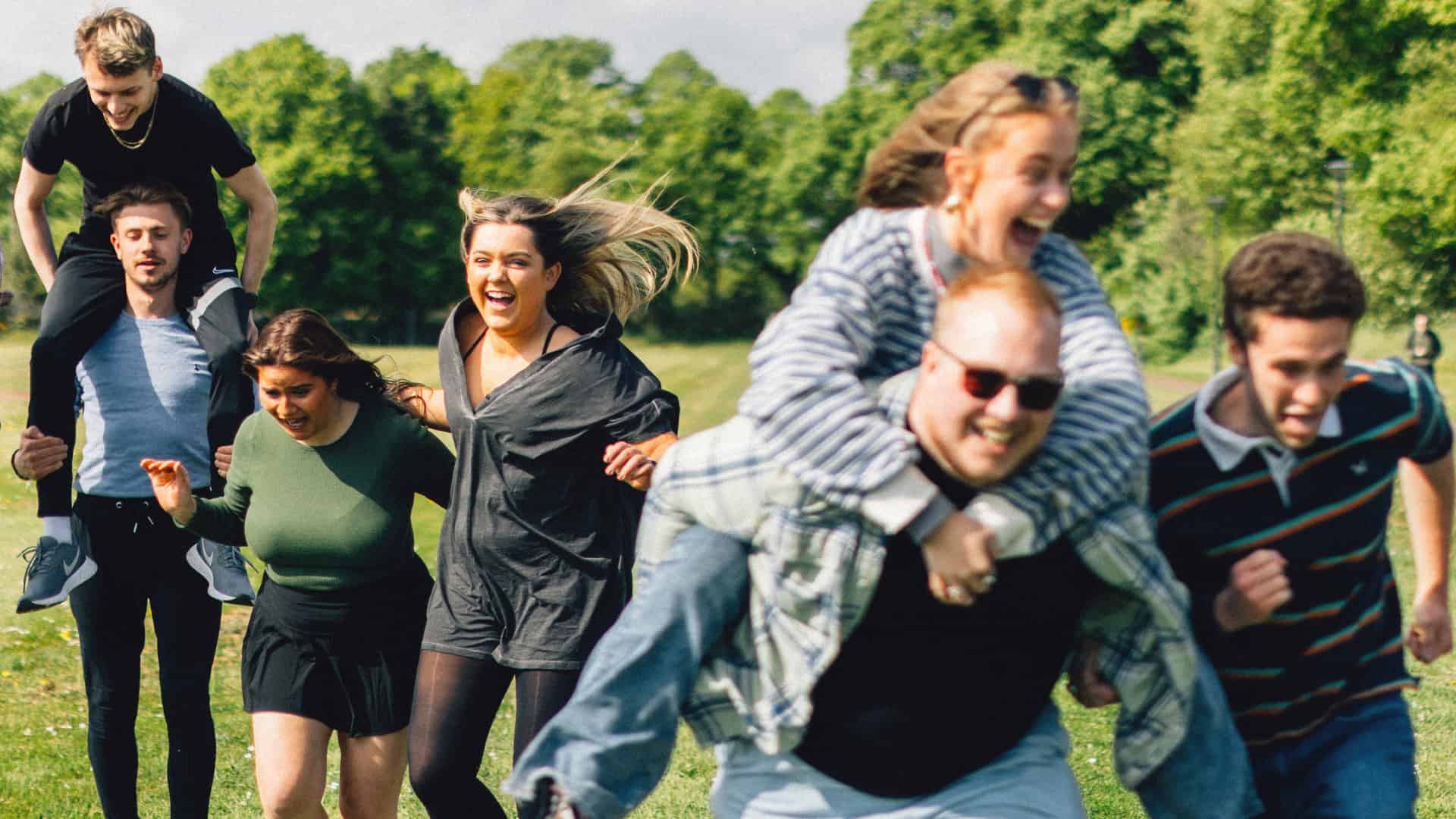 A group of students laughing on Chichester campus