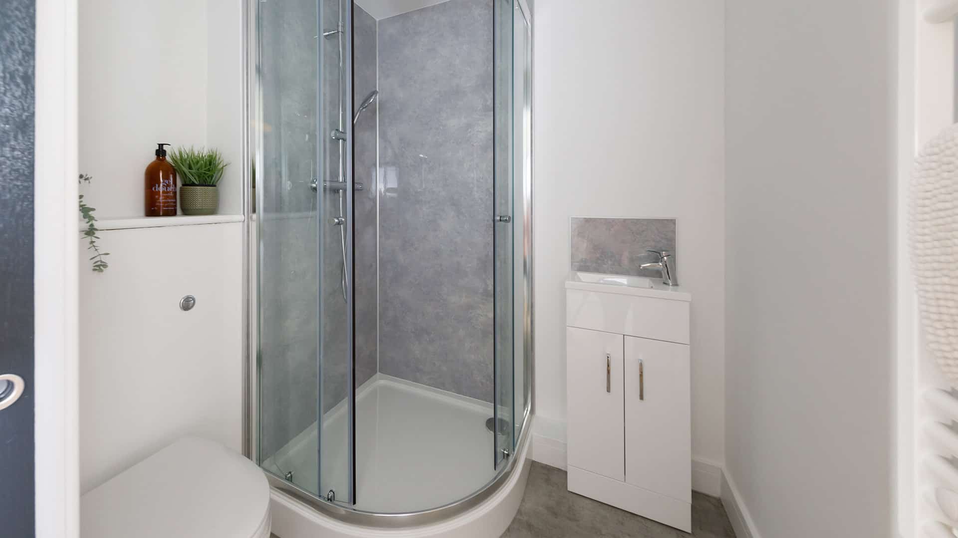 Modern bathroom with toilet and walk-in shower