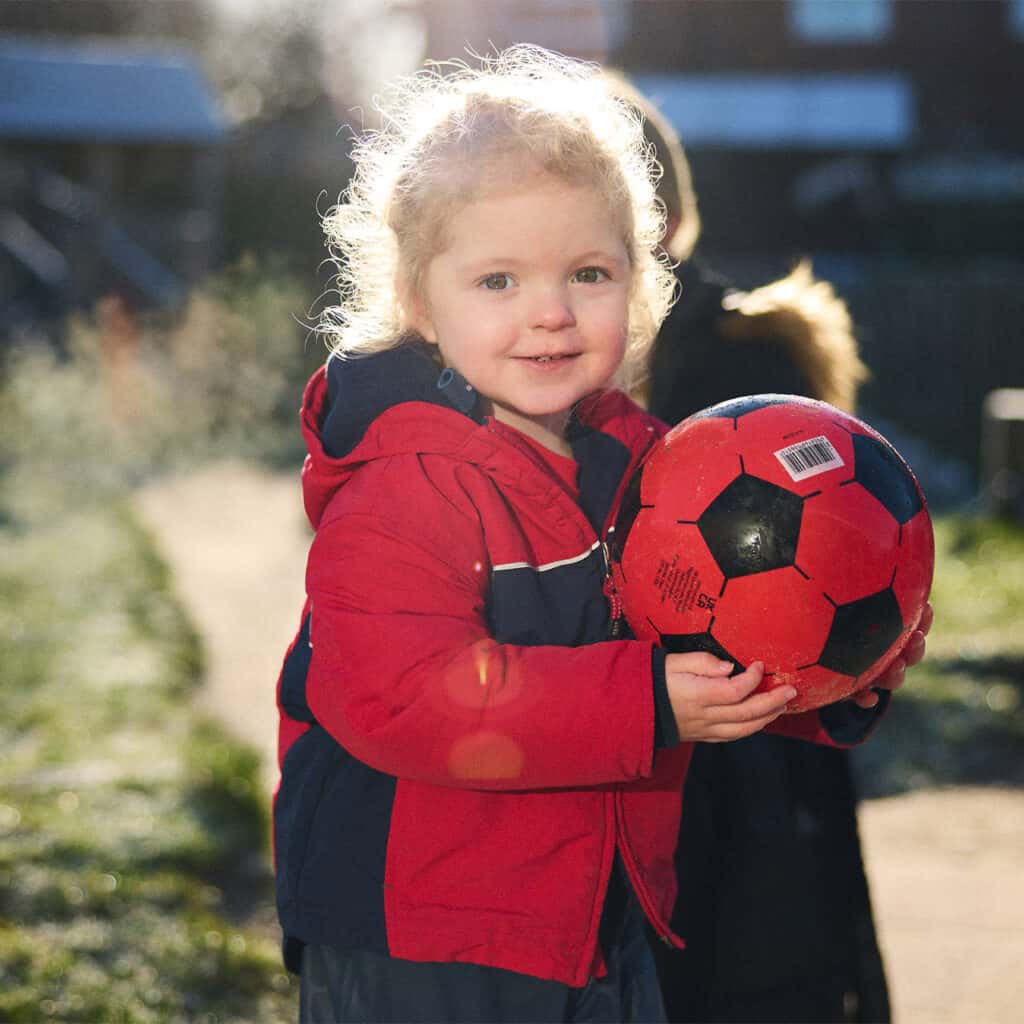 A child holding a football