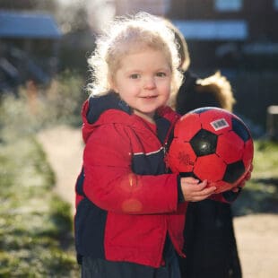 A child holding a football