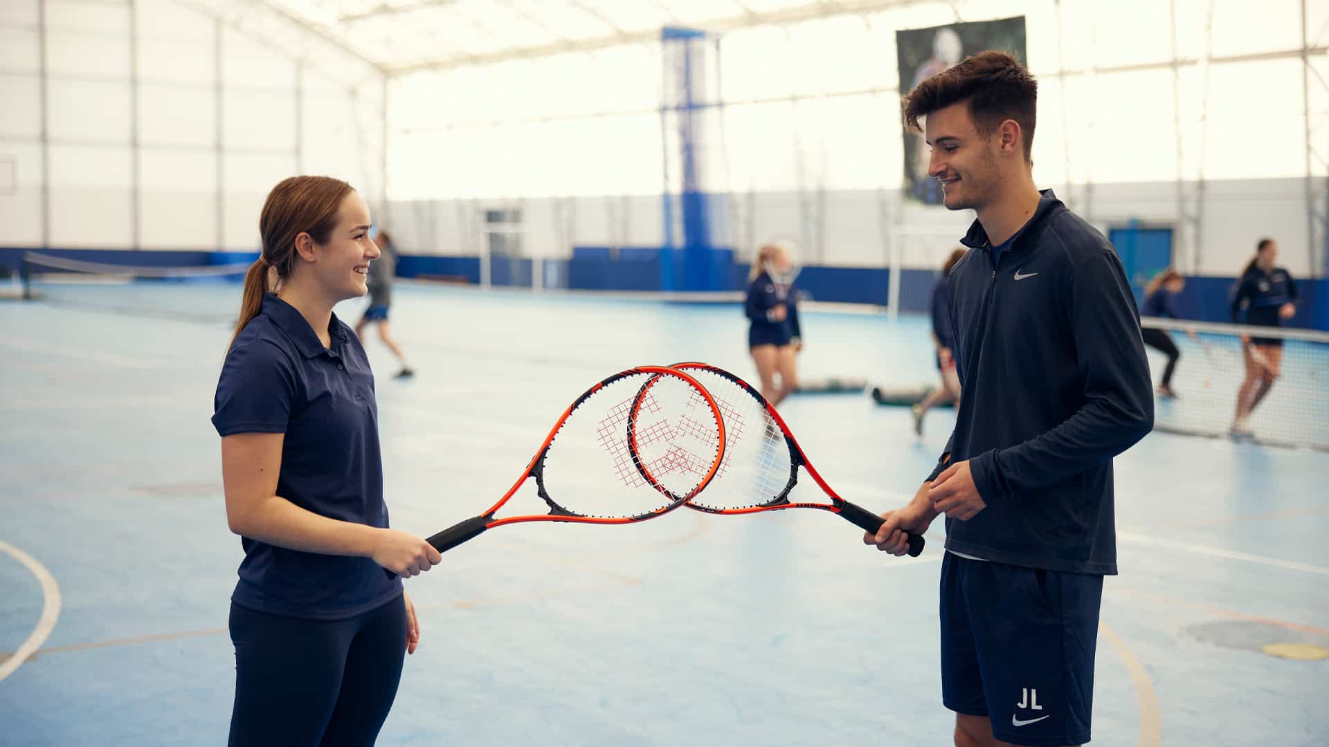 Students with tennis rackets