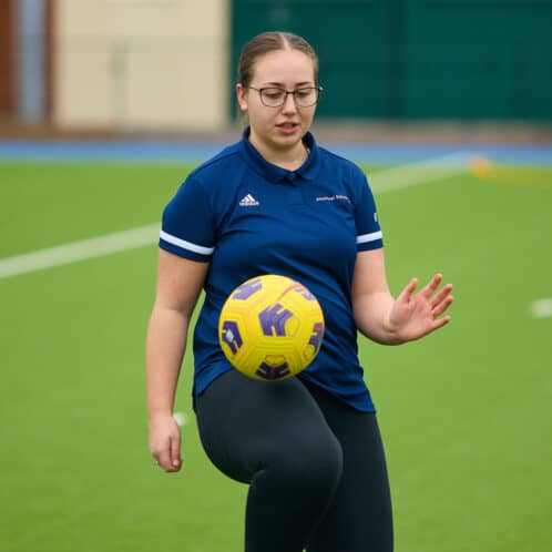 student with football