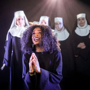 Musical theatre performers on stage in Sister Act