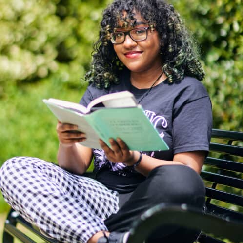 female student reading outside