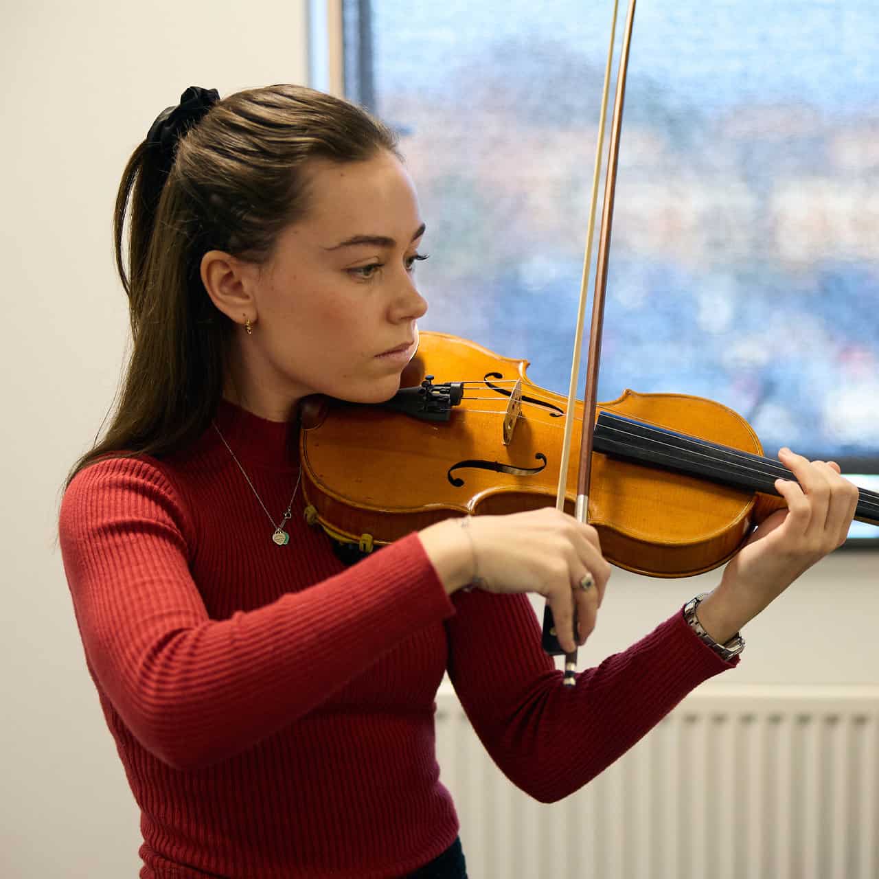 female student playing violin