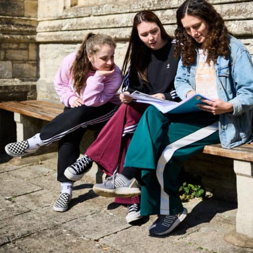 22 Students Cloisters 10 Girls outside Cloisters reading