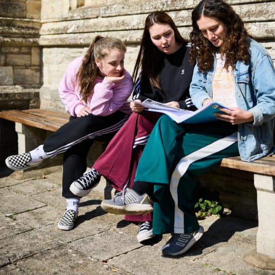 Girls outside Cloisters reading