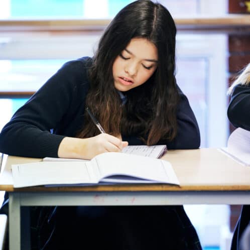 girl sat writing