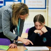 teacher and student looking at work