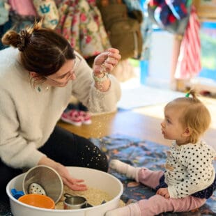 student playing with child at preschool