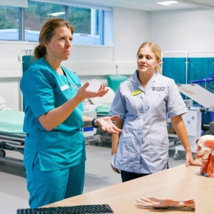 Nursing practitioner explaining to a nursing student