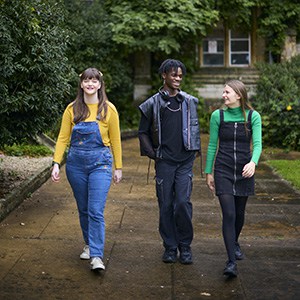 three students walking along Cloisters