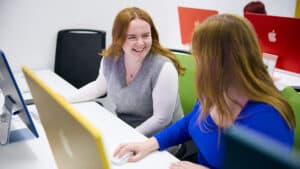 Digital marketing students using Mac in classroom