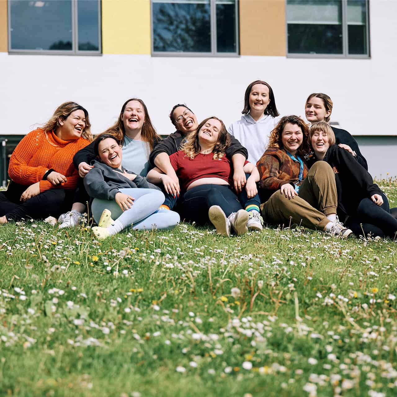 Group of students sat outside the Music Block at University of Chichester
